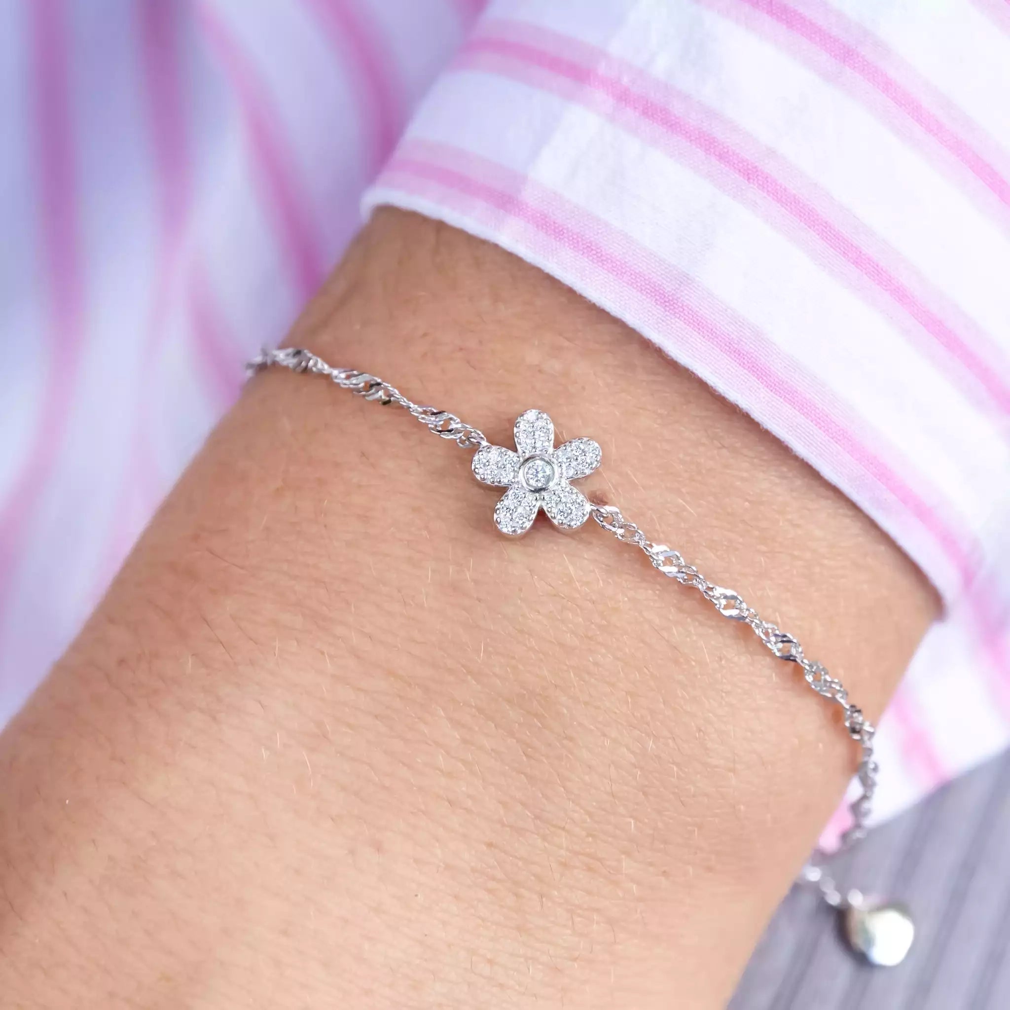 Close-up of Sterling Silver Wildflower Bracelet featuring delicate pavé details, displayed on wrist against natural light