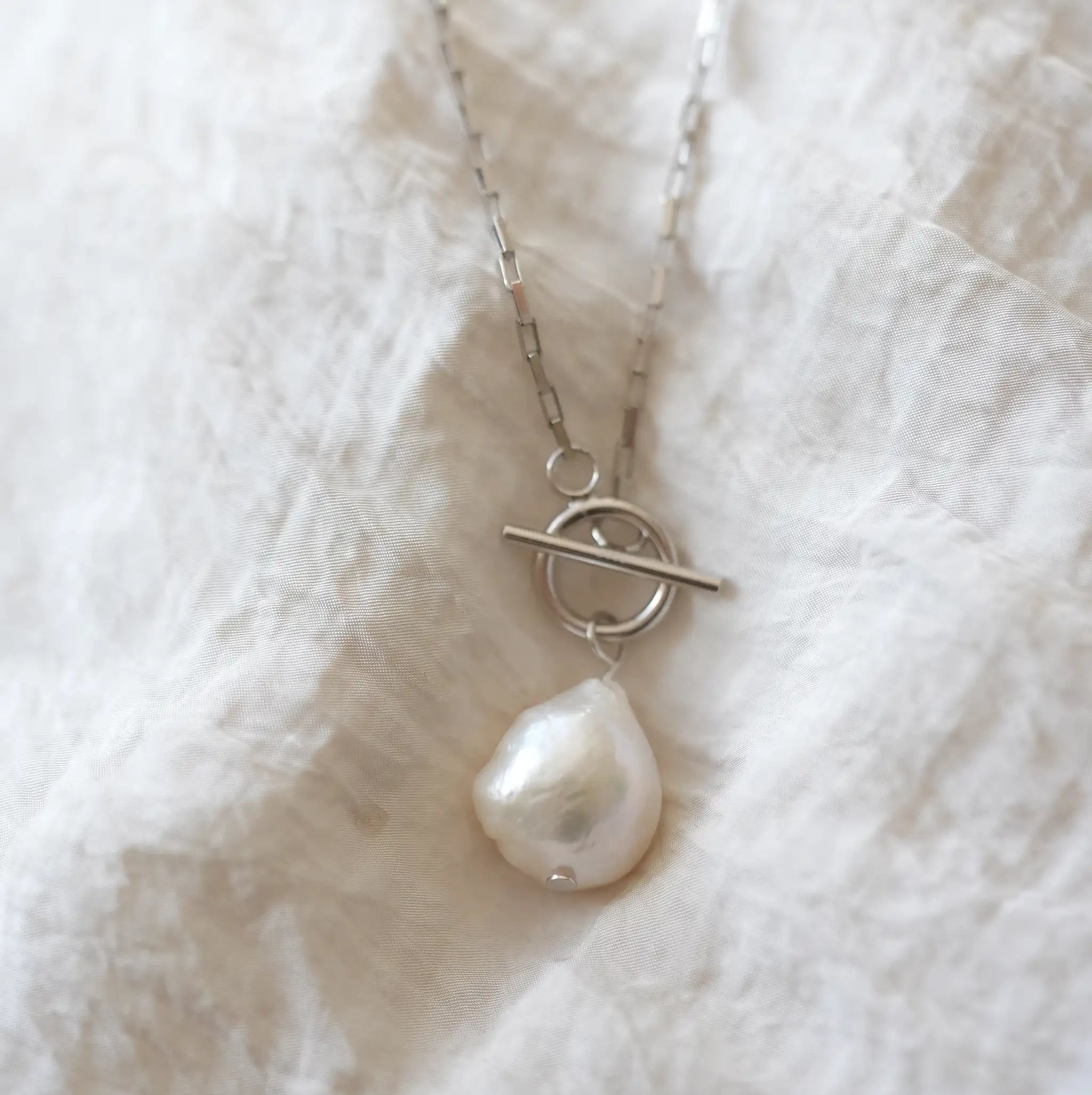 Statement Pearl T-Bar Necklace showcasing unique baroque freshwater pearl and sleek sterling silver box chain design