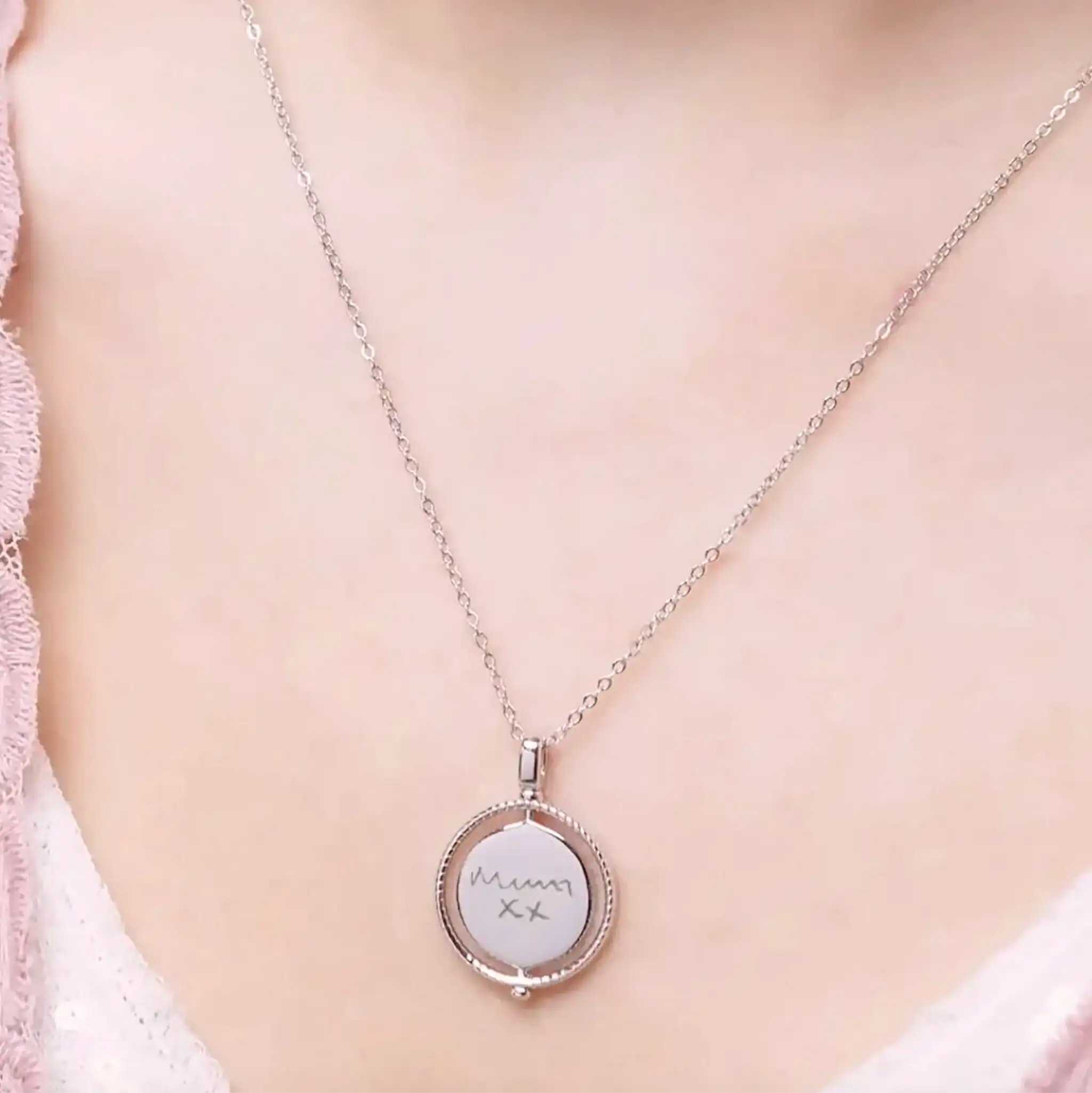 UK designed Sterling Silver Spinner Necklace shown in motion, demonstrating the smooth rotating disc movement with personalised engraving on both sides