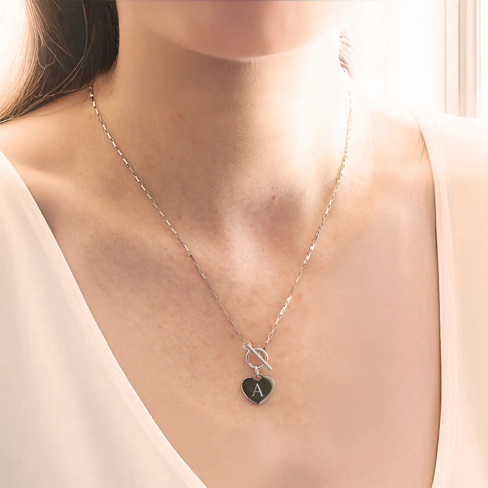 Engraved sterling silver heart charm necklace showing detailed personalisation