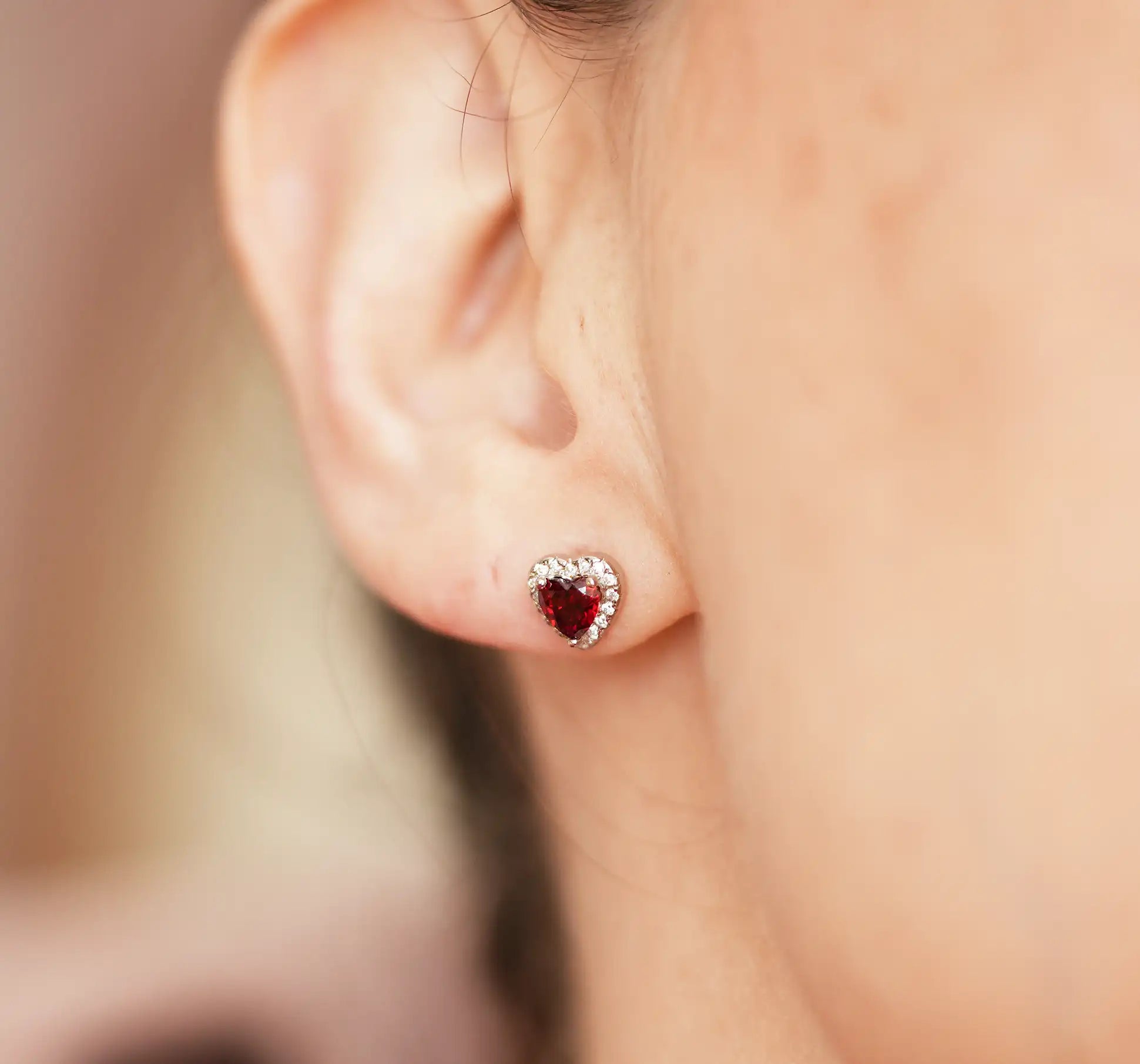 January Birthstone earrings heart studs with a garnet in the centre and cubic zirconia round the edge, made from sterling silver