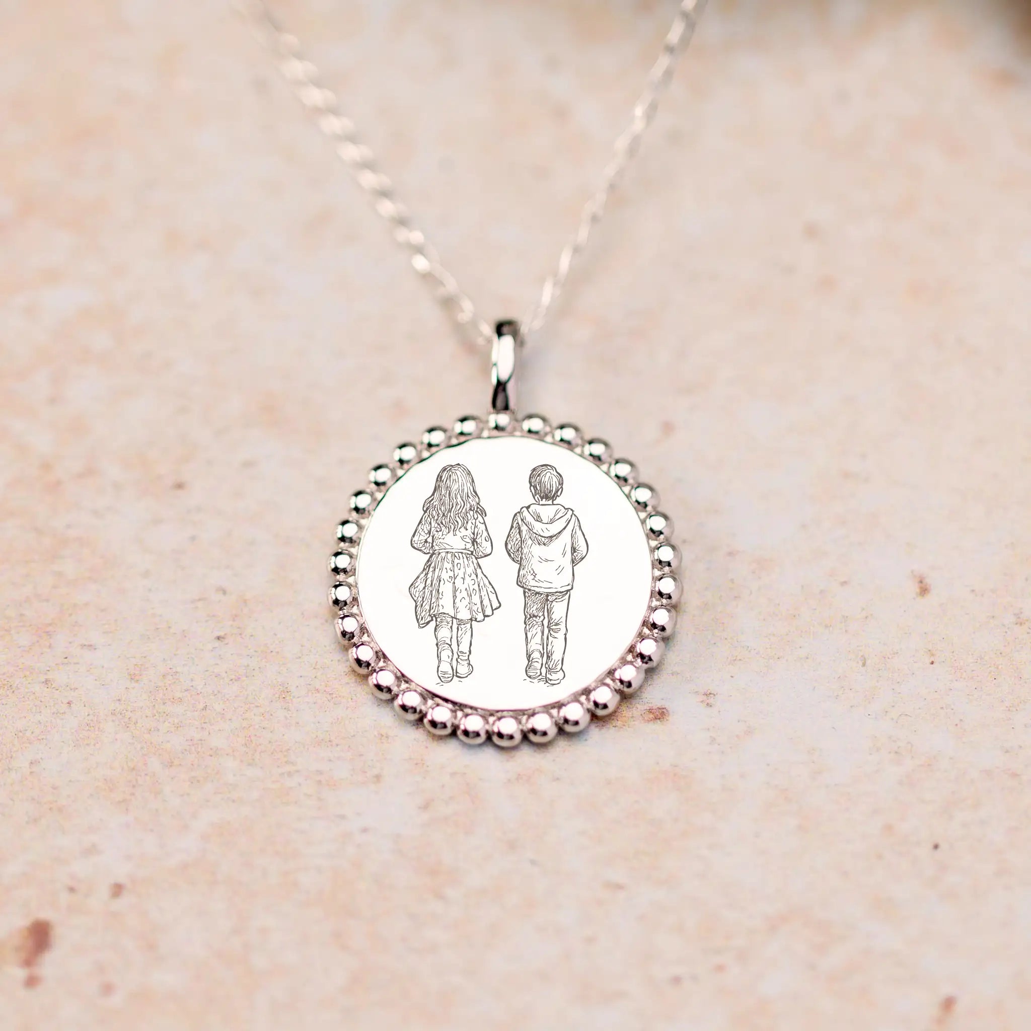 Close-up of laser-engraved photo illustration on sterling silver pendant, showing precise detail and craftsmanship
